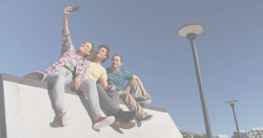 Image of smiling caucasian friends. global sport and digital interface concept digitally generated image.