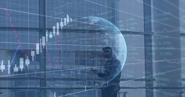 Image of globe, financial data and graphs over caucasian businessman using smartphone. business, finance, economy and technology concept digitally generated image.