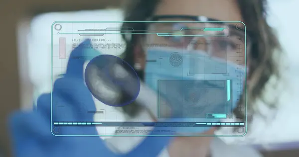 Image of medical data processing on screen over female scientist holding test tube. global coronavirus pandemic, medicine and healthcare concept digitally generated image.