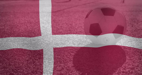 Image of waving denmark flag over football balll. World cup soccer concept digitally generated image.