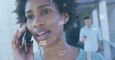 Image of data processing over african american woman with coffee talking on smartphone. Data, networks, digital interface, convenience and communication, digitally generated image.