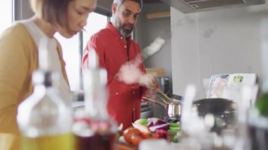 Mutfakta birlikte yemek pişiren farklı çiftlerin ev şeklinin animasyonu. İlişkiler, aşk, birliktelik ve yaşam tarzı konsepti dijital olarak oluşturulmuş video.