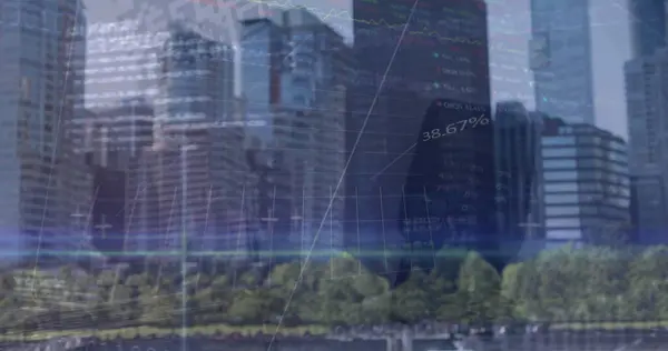 Image of financial graphs and data over cityscape. Global finance, economy and business concept digitally generated image.