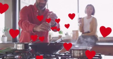 Aşçılığı kucaklayan çeşitli çiftler üzerinde kalp animasyonu. İlişkiler, aşk, birliktelik ve yaşam tarzı konsepti dijital olarak oluşturulmuş video.