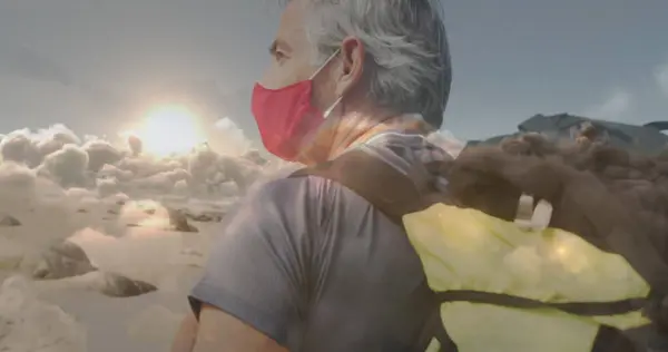 Caucasian Senior Man Face Mask Hiking Coast Fast Moving Clouds — Stock Photo, Image