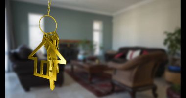 Golden house-shaped keychain hanging in focus, background shows cozy living room. Soft couch and elegant chairs invite relaxation, warm lighting enhances homey feel clipart