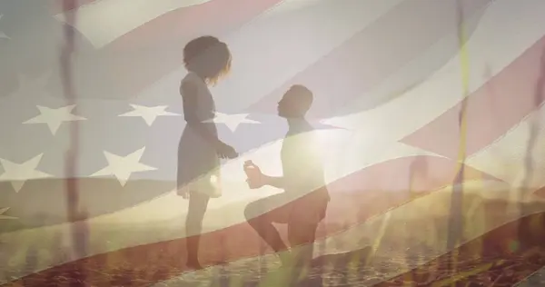 stock image Image of american flag over african american couple proposing. patriotism and celebration concept digitally generated image.