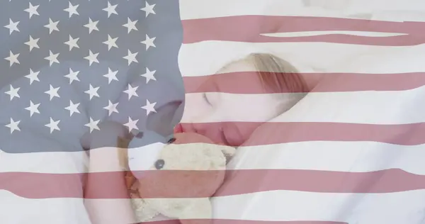 stock image Independence text and american flag waving against caucasian girl sleeping with her teddy bear. american independence and celebration concept