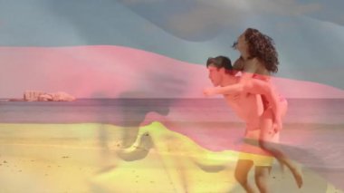 Alman bayrağı animasyonunda sahilde eğlenen bir çift. Seyahat, tatil, Almanya, romantizm, eğlence, turizm