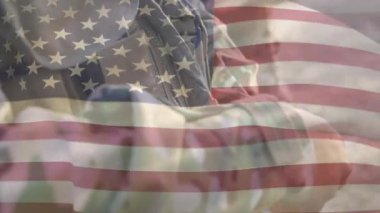 Amerikan bayrağının melez erkek askere karşı canlandırılması. Askerlik, vatanseverlik ve ulusal bayraklar dijital olarak oluşturulmuş video konsepti.