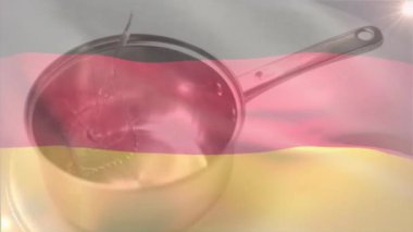 Arka planda Alman bayrağı animasyonu olan tencereye sıvı dökülüyor. Aşçılık, kültür, geleneksel mutfak, aşçılık, yemek