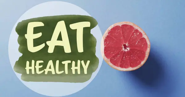 stock image Image of eat healthy text over halved grapefruit on blue background. Fruit, healthy diet and vegan fresh food concept digitally generated image.