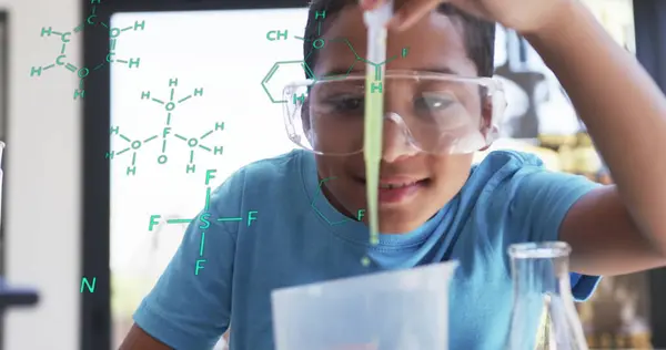 stock image Conducting science experiment, child with safety goggles over chemical formulas image. lab, chemistry, education, learning, research, stem