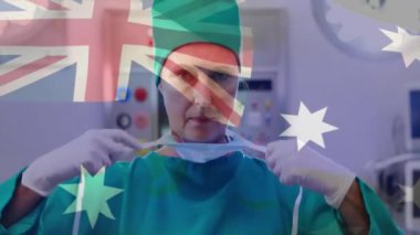 Yüz maskeli beyaz kadın cerrah üzerine Avustralya bayrağı animajı. Tıp, vatanseverlik ve dijital arayüz kavramı, dijital olarak üretilen video.
