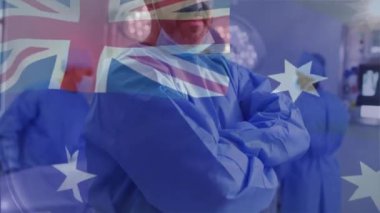 Hastanedeki çift ırklı erkek cerrah yerine Avustralya bayrağının animasyonu. Küresel tıp, sağlık, bayraklar ve dijital arayüz kavramı, dijital olarak oluşturulmuş video.