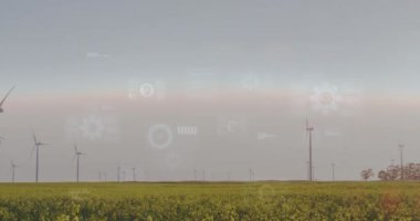 Rüzgâr türbinleri dijital veri işleme animasyonuyla birlikte arazide. Yenilenebilir enerji, rüzgar gücü, sürdürülebilirlik, yeşil enerji, teknoloji