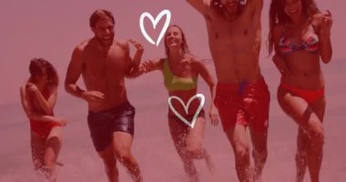 Sahilde dans eden ve gülen arkadaşlar kalp şeklinde animasyonlar yapar. yaz, eğlence, neşe, mutluluk, grup, tatil kavramı