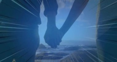 El ele tutuşan, parlak ışık patlaması animasyonunda yürüyen bir çift. Aşk, romantizm, birliktelik, birlik, aydınlık, bağlantı