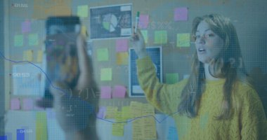 Image of financial data processing over diverse business people in office. global business, finances and digital interface concept digitally generated image.