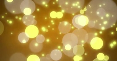Altın arka planda parlayan sarı bokeh ışıkları animasyon yapıyor. Şenlikli, soyut konsept