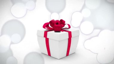 Konfeti ve baloncuklar kırmızı kurdeleli beyaz hediye kutusunun üzerinde. Kutlama, parti, festival, sürpriz, hediye, doğum günü