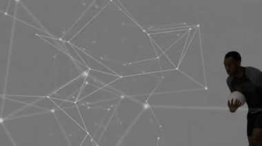 Ragbi oynuyorlar, atletler ağ bağlantıları üzerinden topla koşuyorlar. Spor, takım çalışması, teknoloji, dijital, oyun