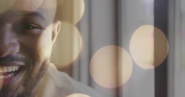 Arka planda bokeh ışıkları olan gülümseyen kişi. Portre