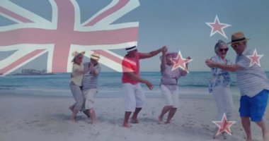 Yeni Zelanda bayrağı ve yıldız animasyonuyla sahilde dans eden yaşlılar. Kutlama, yaşlılık, dans, neşe