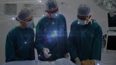 Doktorlar ameliyathane üzerinde ağ bağlantıları olan ameliyatlar yapıyorlar. Sağlık, teknoloji, yenilik, tıbbi, takım çalışması, bağlantı