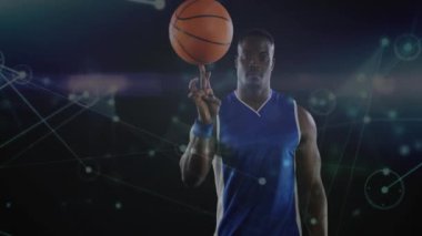 Parmak üzerinde dönen basketbol, arka planda ağ bağlantıları olan bir atlet. Spor, dijital, yetenek, teknoloji, bağlantı, hareket