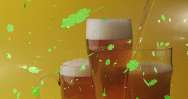 Image of st patrick's day green shamrock falling over beer glasses. St patrick's day, irish tradition and celebration concept digitally generated image clipart