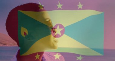 Kumsalda gülümseyen birinin güneş gözlüğü takması üzerine Grenada bayrağı animasyonu. Ulusal bayrak, tatil, tropikal, yaz, neşe, yaşam tarzı