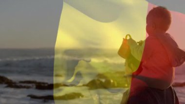 Belçika bayrağının beyaz bir annenin bebeğini taşıması. Yaşam tarzı, bayraklar ve vatanseverlik konsepti dijital olarak oluşturulmuş video.