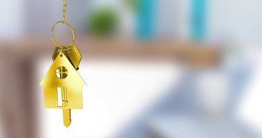 Image of gold house key fob and key dangling over out of focus interiors with copy space. Home ownership concept digitally generated image. clipart