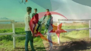 Cezayir bayrağının kırsal kesimde çocuklu beyaz ebeveynler üzerinde canlandırılması. Yaşam tarzı, bayraklar ve vatanseverlik konsepti dijital olarak oluşturulmuş video.