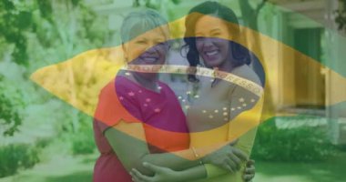 Brezilya bayrağının, yetişkin kızı olan yaşlı Afro-Amerikan kadın üzerinde canlandırılması. Vatanseverlik, yaşam tarzı ve aile konsepti dijital olarak oluşturulmuş video.