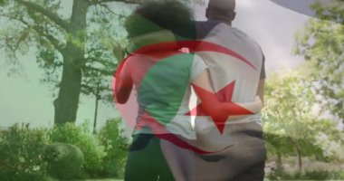 Afro-Amerikan çiftin bahçede sarılıp yürümesi üzerine Cezayir bayrağının animasyonu. Vatanseverlik, yaşam tarzı ve ilişkiler konsepti dijital olarak oluşturulmuş video.