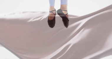 Image of caucasian female ballerina over floating cloth on white background. Thoughts, dance and lifestyle, digitally generated image. clipart