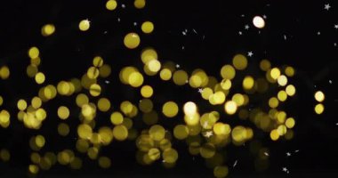 Golden bokeh lights with star shapes animation on black background. abstract, glitter, sparkle, festive, glow, shine