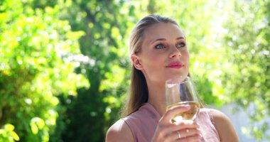 Beautiful woman having wine at restaurant clipart