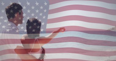 Amerikan bayrağı, kucaklaşan ve okyanusa bakan bir çiftin üzerinde. Vatanseverlik, aşk, romantizm, birlik, kutlama, Americana