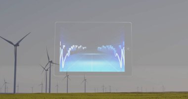 Rüzgar türbinlerinin üzerindeki veri görüntüsüyle tablet arayüzü. Yenilenebilir enerji, teknoloji, rüzgar gücü, sürdürülebilirlik, dijital