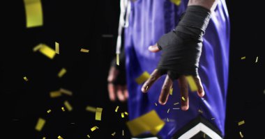 Afrika kökenli Amerikalı erkek boksörün üzerine düşen konfeti resmi. Spor, kazanma ve kutlama konsepti dijital olarak oluşturulmuş imaj.