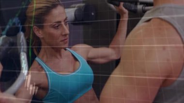 Spor salonunda egzersiz yapan, borsa veri animasyonu yapan insanlar. Fitness, teknoloji, finans, egzersiz, eğitim, ekonomi