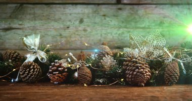 Image of glowing lights moving over fir tree cones christmas decorations. christmas, tradition and celebration concept digitally generated image. clipart