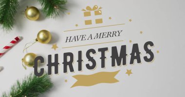 Image of merry christmas text over christmas decorations. Christmas, celebration and digital interface concept digitally generated image. clipart