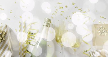 Image of confetti and champagne bottle with glasses. New year's eve, christmas, festivity, celebration and tradition concept digitally generated image. clipart