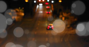 Bokeh light image over blurred night street scene with traffic lights. city, urban, neon, glow, evening, vibrant clipart