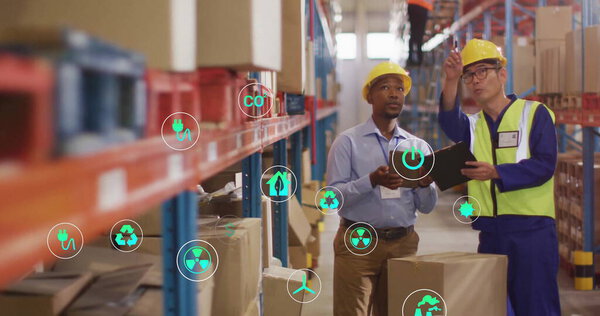 Image of eco icons and data processing over diverse people working in warehouse. Global shipping, finance, business, connections, computing and data processing concept digitally generated image.