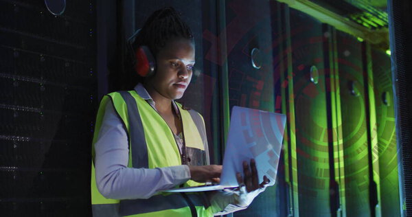 Image of digital data processing over african american it female engineer by computer servers. Global connections, computing and data processing concept digitally generated image.